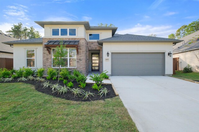 16006 Ruby Laurel Ct, Conroe, TX 77302 - prairie-style home with stucco siding, driveway, an attached garage, and a front lawn