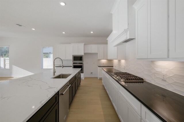 16006 Ruby Laurel Ct, Conroe, TX 77302 - kitchen with a sink, stainless steel appliances, healthy amount of natural light, white cabinetry, and recessed lighting