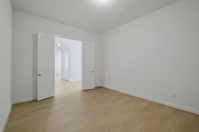 16006 Ruby Laurel Ct, Conroe, TX 77302 - empty room featuring light wood-style floors and baseboards