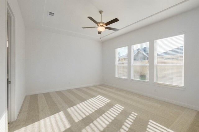 16006 Ruby Laurel Ct, Conroe, TX 77302 - unfurnished room with light colored carpet, a ceiling fan, baseboards, and a raised ceiling