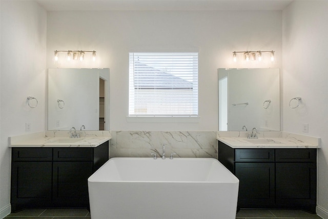 16006 Ruby Laurel Ct, Conroe, TX 77302 - full bath with a freestanding bath, two vanities, and tile patterned flooring