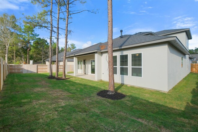 16006 Ruby Laurel Ct, Conroe, TX 77302 - back of property featuring stucco siding and roof with shingles