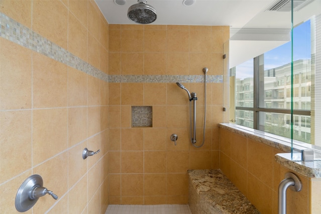 bathroom with a tile shower