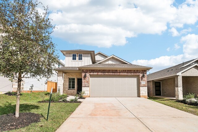 view of front of home with a garage and a front lawn