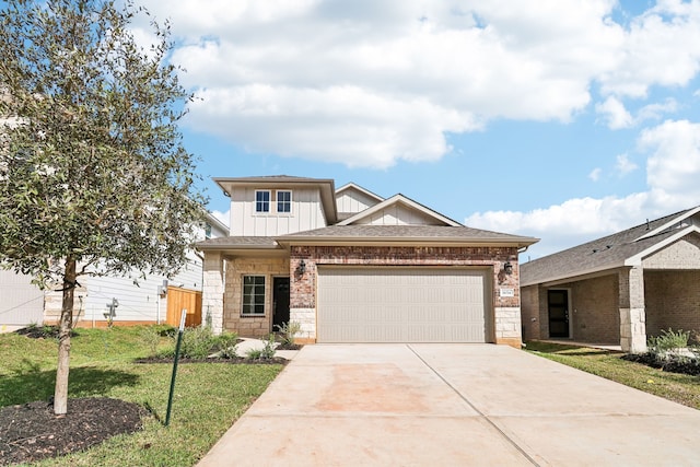 view of front of property featuring a garage and a front lawn