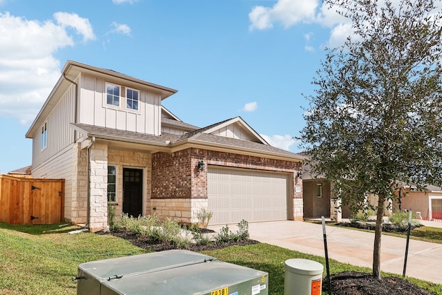 view of front of property featuring a front yard and a garage