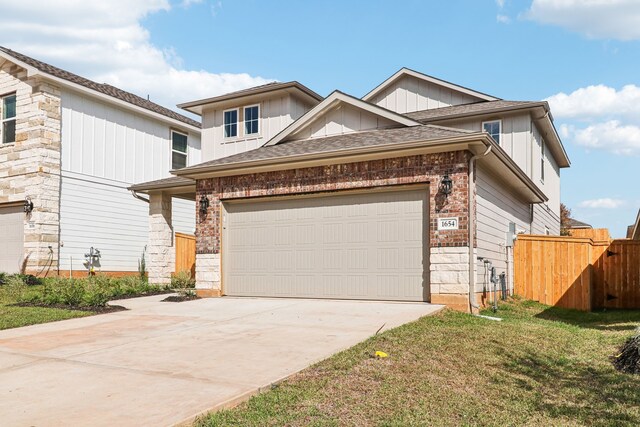 view of front of property with a garage and a front lawn