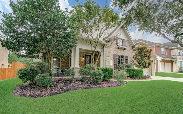 view of front of property featuring a front yard and a garage