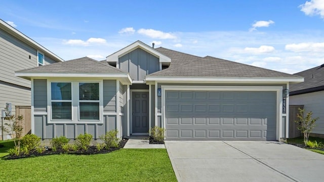 view of front of home with a garage and a front yard