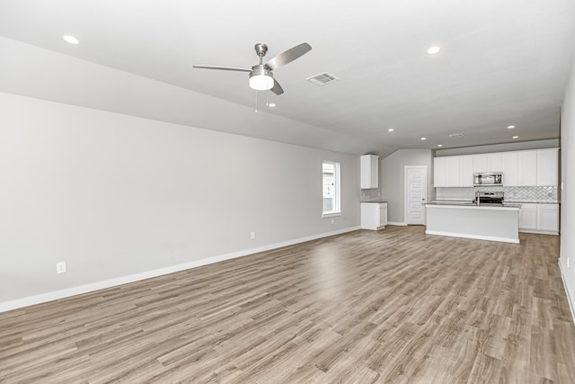 unfurnished living room with light wood-type flooring and ceiling fan