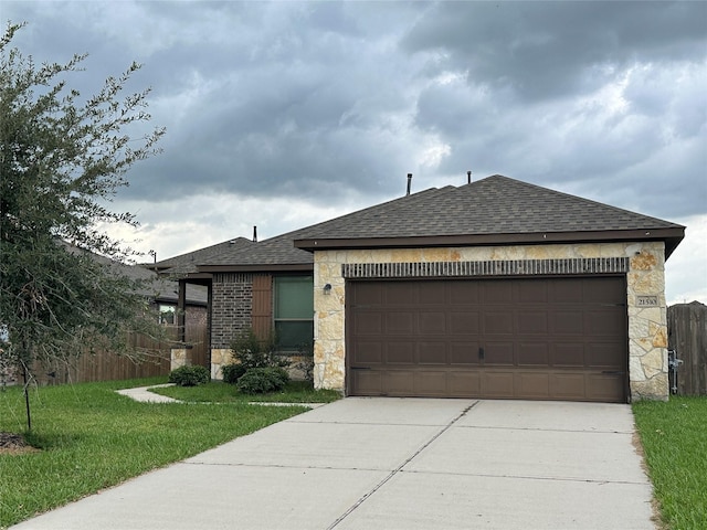 view of front of property featuring roof with shingles, concrete driveway, fence, a garage, and stone siding