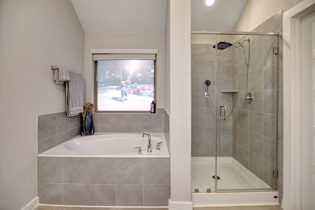 bathroom featuring shower with separate bathtub and lofted ceiling