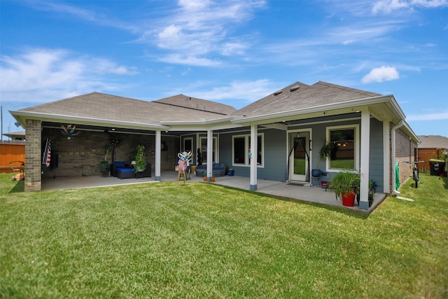 rear view of house featuring a patio and a yard