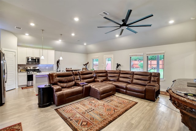 living room with ceiling fan and light hardwood / wood-style floors