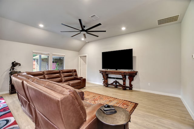 living room featuring light hardwood / wood-style floors, ceiling fan, and vaulted ceiling