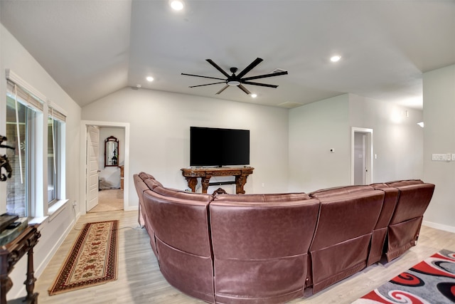 living room featuring lofted ceiling, light hardwood / wood-style floors, and ceiling fan