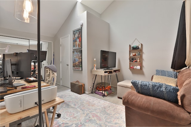 office with light hardwood / wood-style flooring and lofted ceiling