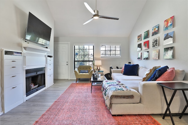 living room featuring ceiling fan, lofted ceiling, and hardwood / wood-style flooring