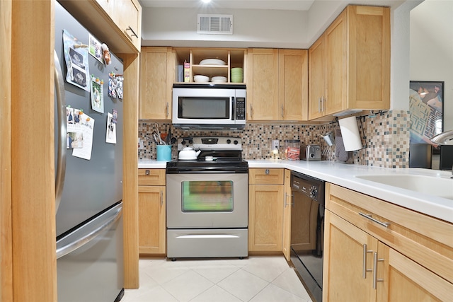 kitchen featuring decorative backsplash, light brown cabinetry, sink, and appliances with stainless steel finishes