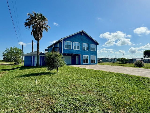 view of front of house featuring a garage and a front lawn