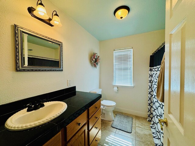 bathroom with tile patterned floors, toilet, and vanity