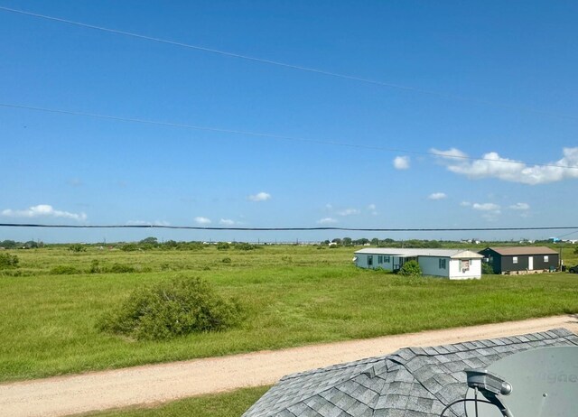 exterior space with a rural view and a yard