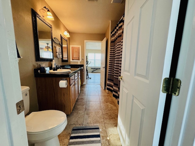 bathroom with vanity, tile patterned flooring, and toilet