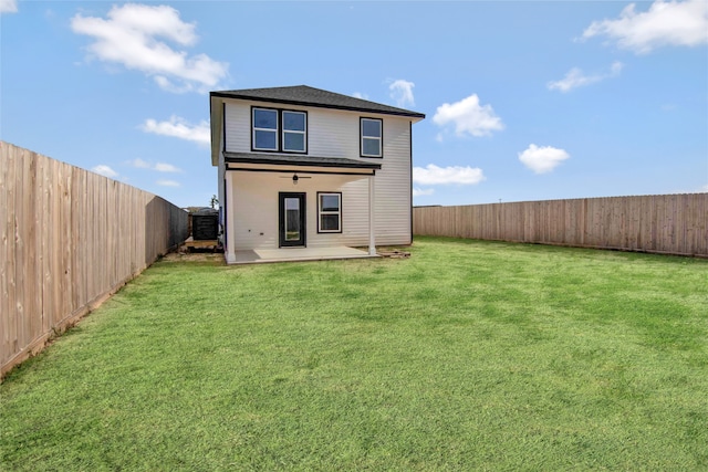 back of house with a lawn