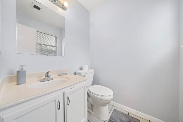 bathroom with tile patterned floors, vanity, and toilet