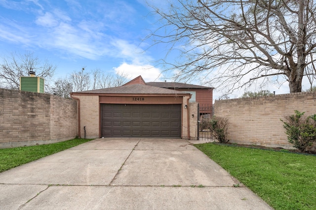 garage featuring driveway, a gate, and fence