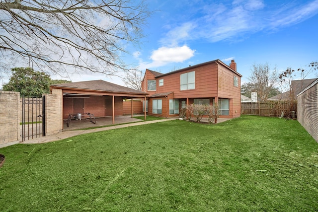 rear view of house featuring a lawn and a patio area