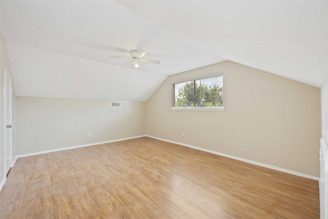 bonus room with vaulted ceiling, ceiling fan, and light wood-type flooring