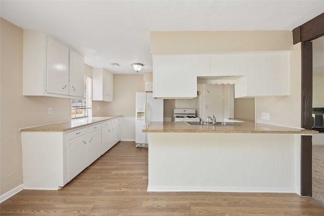 kitchen with sink, kitchen peninsula, light hardwood / wood-style floors, white refrigerator with ice dispenser, and white cabinetry