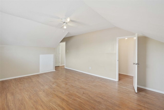 additional living space with light wood-type flooring, ceiling fan, and lofted ceiling