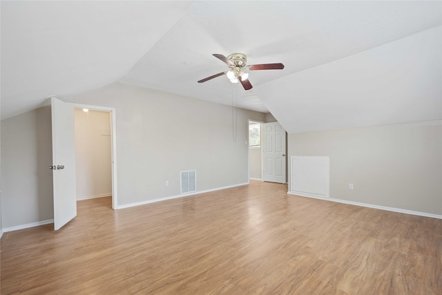 bonus room with vaulted ceiling, ceiling fan, and light wood-type flooring