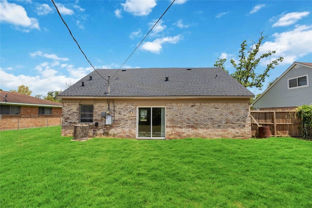 back of property featuring a lawn