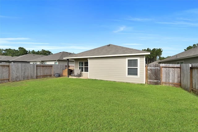 rear view of house with a patio area and a lawn