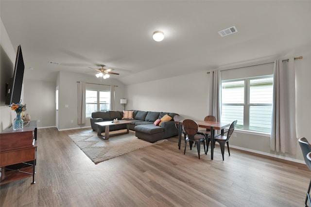 living room featuring light wood-type flooring and ceiling fan