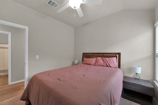 bedroom featuring wood-type flooring, ceiling fan, and vaulted ceiling