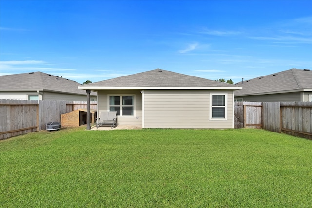 rear view of property featuring a patio and a lawn