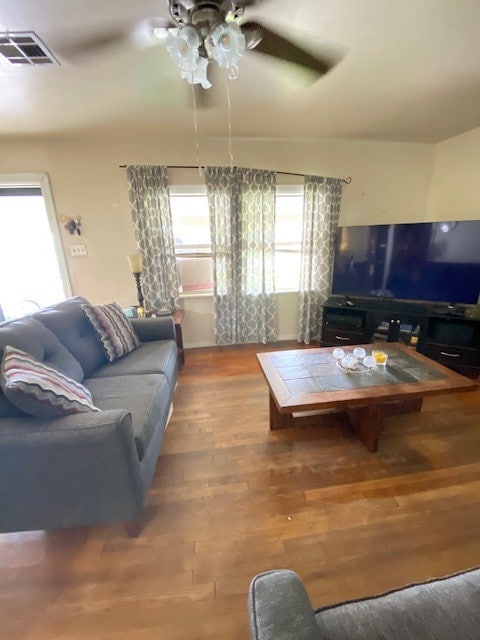 living room with ceiling fan, plenty of natural light, and hardwood / wood-style floors