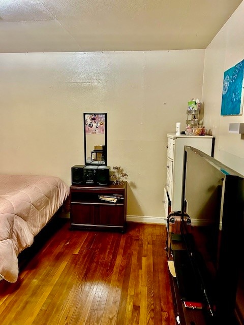 bedroom with hardwood / wood-style floors and a textured ceiling