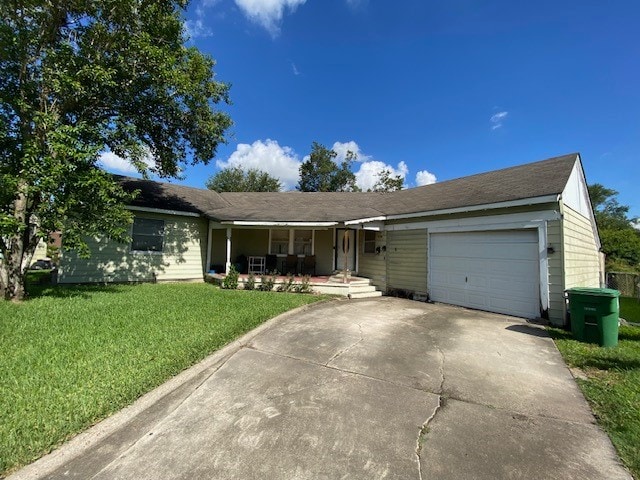 single story home featuring a garage and a front lawn