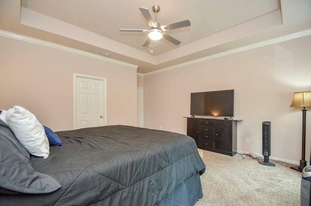 bedroom with a raised ceiling, ceiling fan, crown molding, and light colored carpet