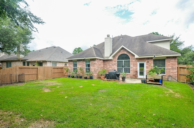 back of property featuring a lawn and a patio