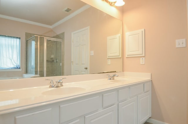 bathroom with vanity, a shower with door, and crown molding