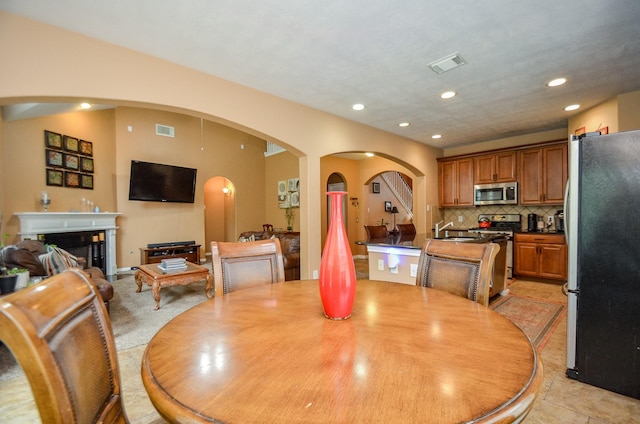 tiled dining room featuring sink