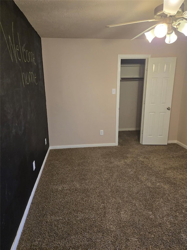 unfurnished bedroom featuring carpet flooring, a textured ceiling, and ceiling fan