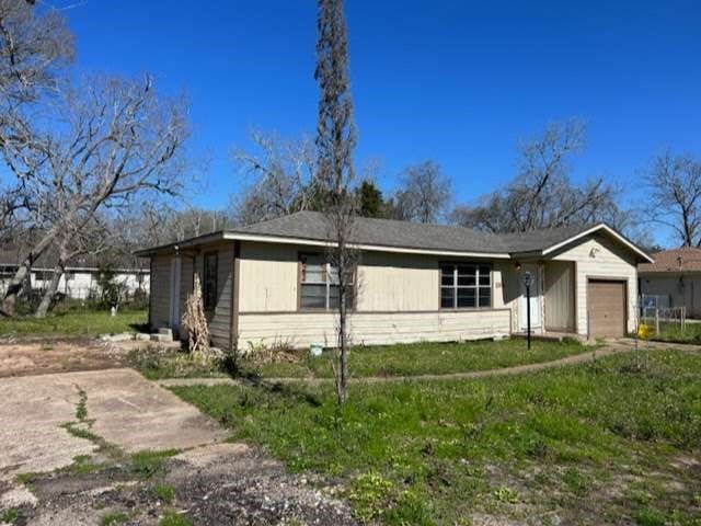 view of side of home featuring a garage