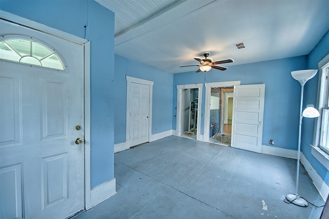 entrance foyer with concrete flooring and ceiling fan